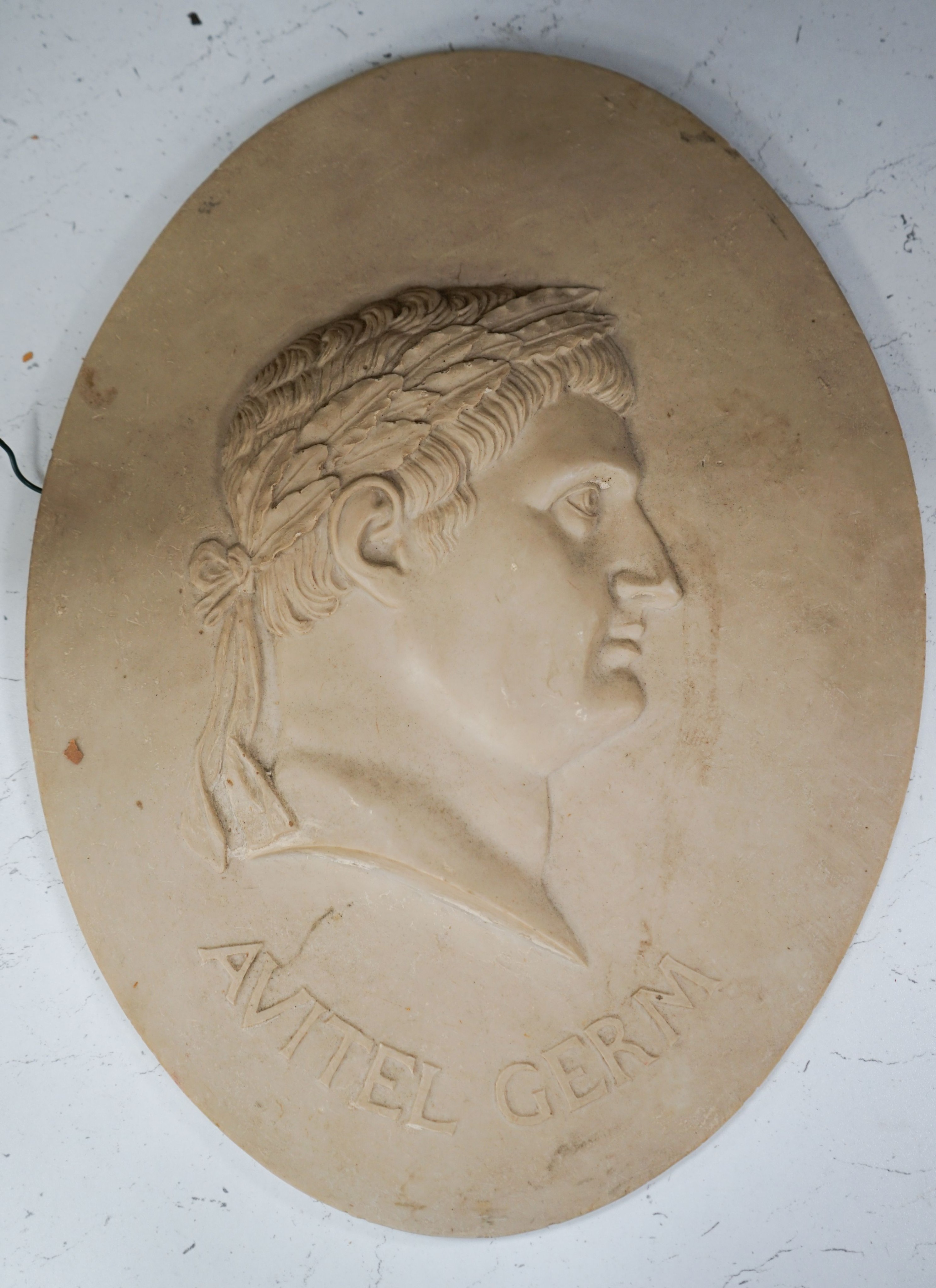 A resin composite bust roundel, after the antique, 'AVITEL GERM'
